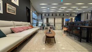 a living room with a couch and a table at Hotel Atrium Jongno in Seoul