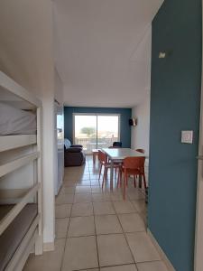 a living room with a table and a dining room at Studio vue mer in Cervione