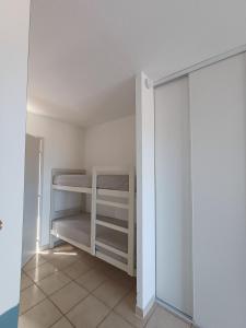 a small room with white shelves and a closet at Studio vue mer in Cervione
