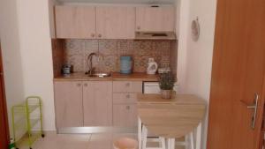 a small kitchen with a sink and a counter at Kampos Rooms in Palaiochora