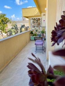 a patio with a table and chairs on a balcony at A casa di Nonna Maria in Marsala