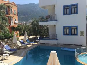 a hotel with a swimming pool next to a building at Lizo Hotel in Kalkan