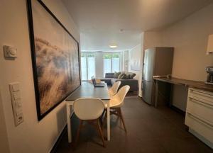 eine Küche und ein Wohnzimmer mit Tisch und Stühlen in der Unterkunft Apart Halver in Halver