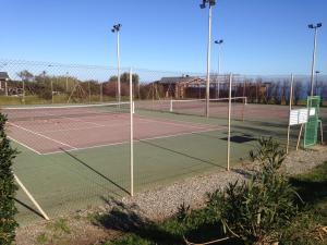 a tennis court with two tennis courts at Studio vue mer in Cervione