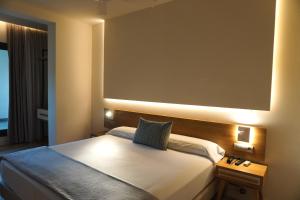 a hotel room with a bed and a large window at Hotel Brisamar Suites in Comarruga +93 photos