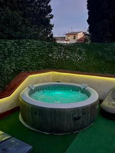 a circular hot tub in a garden with at Empoli Charm in Empoli