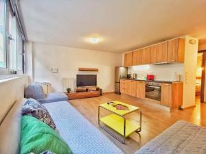 a living room with a couch and a tv at Cozy & Modern Flat for 5 in Athens in Athens