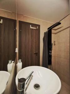a bathroom with a white sink and a shower at Cozy & Modern Flat for 5 in Athens in Athens +15 photos