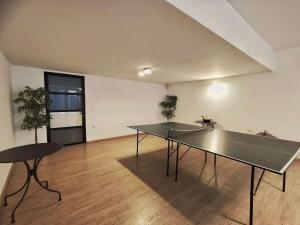 a ping pong table in an empty room with a table at Cozy & Modern Flat for 5 in Athens in Athens