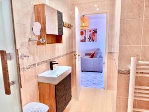 a small bathroom with a sink and a toilet at Maison Bellebat - proche d'Orleans in Orléans