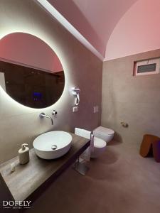a bathroom with a sink and a toilet at Dofely Suites - Tritone in Polignano a Mare