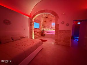 a bedroom with a bed in a red room at Dofely Suites - Tritone in Polignano a Mare