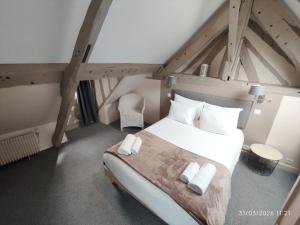 a bedroom with a large white bed in a attic at Les Cascades - Hôtel de Charme in Honfleur