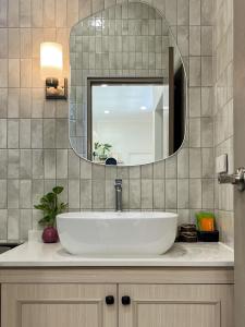a bathroom with a white sink and a mirror at Cococreek Kohkood in Ban Khlong Mat +28 photos
