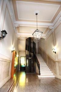 a hallway with stairs and a chandelier in a building at Primo Piano in Sparano in Bari