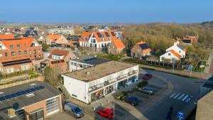 an aerial view of a town with cars parked in a parking lot at Ooststraat 25 in Zoutelande