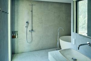 a bathroom with a shower and a tub and a sink at Hiire IZU OLIVE in Ito