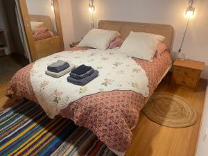 a bedroom with a bed with towels on it at Les chambres de La Serre in Camarès