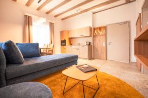 a living room with a couch and a table at Weinhotel OFFENSTEIN ERBEN in Eltville
