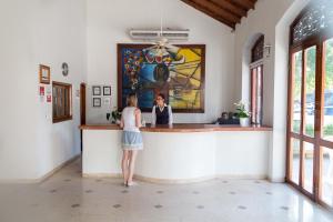 a woman standing at a counter in a restaurant at San Martin Cartagena in Cartagena de Indias