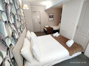 a hotel room with a bed in a room at Les Cascades - Hôtel de Charme in Honfleur +26 photos