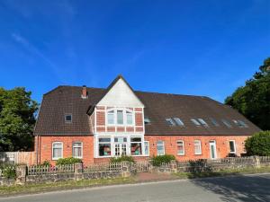 a red brick house with a black roof at INTERGO Apartments in Brackel