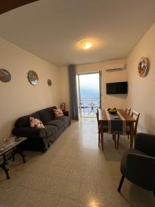 a living room with a couch and a table at Ambra Holiday House in Furore