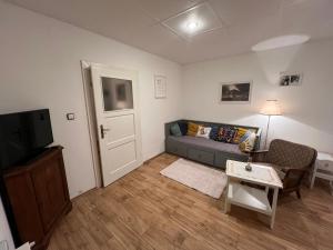 a living room with a couch and a tv at U babičky in Suchov