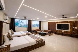 a hotel room with two beds and a flat screen tv at Hotel Shivdev International, near New Delhi Railway Station & City Centre in New Delhi