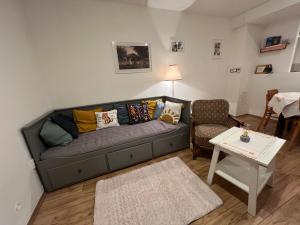 a living room with a couch and a table at U babičky in Suchov