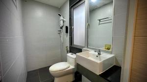 a bathroom with a white toilet and a sink at Swing & Pillows - Sentul Titiwangsa in Kuala Lumpur +31 photos