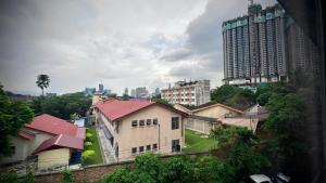 a group of houses in a city with tall buildings at Swing & Pillows - Sentul Titiwangsa in Kuala Lumpur