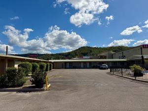 an empty parking lot in front of a building at Ashwood Motel in Gosford