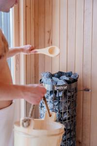 a woman holding a wooden spoon next to a basket of charcoal at Bay Zatoka Radzyń in Radzyń +55 photos