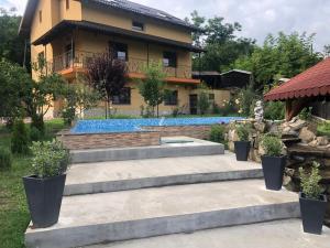 a house with a swimming pool in front of it at Vila Cristal in Târgu Ocna