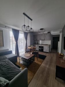 a living room with a couch and a table at ApuLux Apartments in Alba Iulia +4 photos