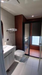 a bathroom with a toilet and a sink and a shower at MM No6 Villa in Luodong