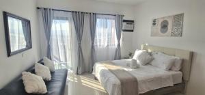 a bedroom with a bed and a large window at The Crib at Royal Oceancrest Mactan in Lapu Lapu City