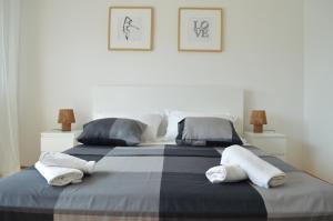two beds in a bedroom with towels on them at Anka Cozy Apartment in Galovac