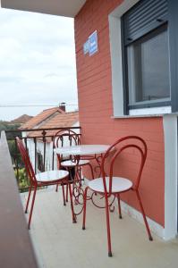 a row of tables and chairs on a patio at Anka Cozy Apartment in Galovac