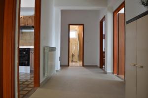 a hallway of a house with a hallway leading to a door at Anka Cozy Apartment in Galovac +16 photos