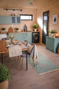 a kitchen with a wooden table and a dining room at Mestia Inn Chalet in Mestia