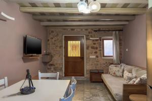 a living room with a couch and a tv at Vetus Oppidum Boutique Guesthouse in Chania