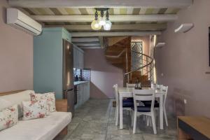 a living room with a couch and a table and chairs at Vetus Oppidum Boutique Guesthouse in Chania