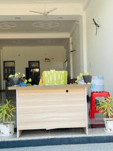 a dresser in a living room with potted plants at Hotel Devansh , Niwai in Palāi