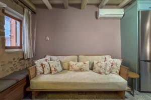 a couch in a living room with pillows on it at Vetus Oppidum Boutique Guesthouse in Chania +42 photos