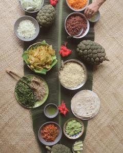 a table topped with bowls of different types of food at Betelnut Eco-Lodge Sumba in Lambatama