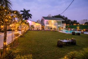 a house with a yard with a table and lights at Amber Resort & Spa in Indore