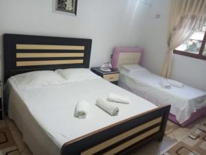 a bedroom with two beds with towels on them at Refika in Berat