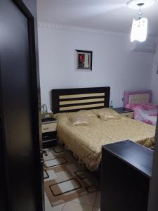 a bedroom with a bed and a desk and a door at Refika in Berat